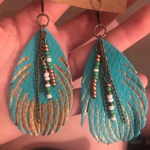 Turquoise feathered earrings with embellishments
